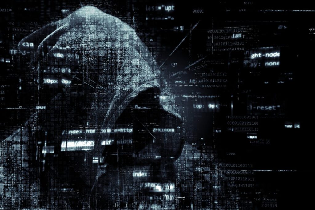 Abstract image of a hooded individual behind code